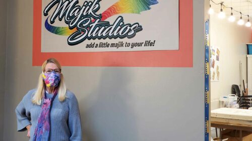 Pam Granger stands in front of her studio sign, Majik Studios, Asheville, NC.