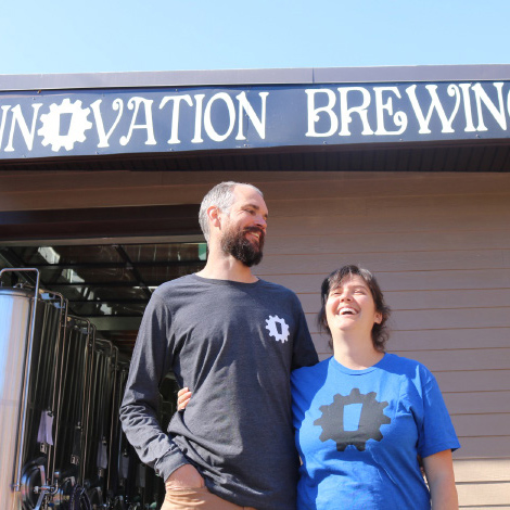 Founders of Innovation Brewing standing in front of their brewery—Mountain BizWorks.