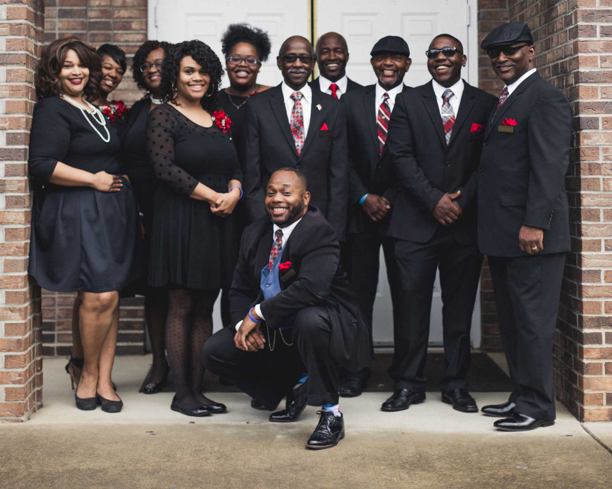 Team of Avery's Memorial Chapel gathered in front of the chapel doors—Mountain BizWorks.